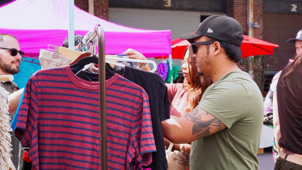 Man and woman looking through our free clothing racks.