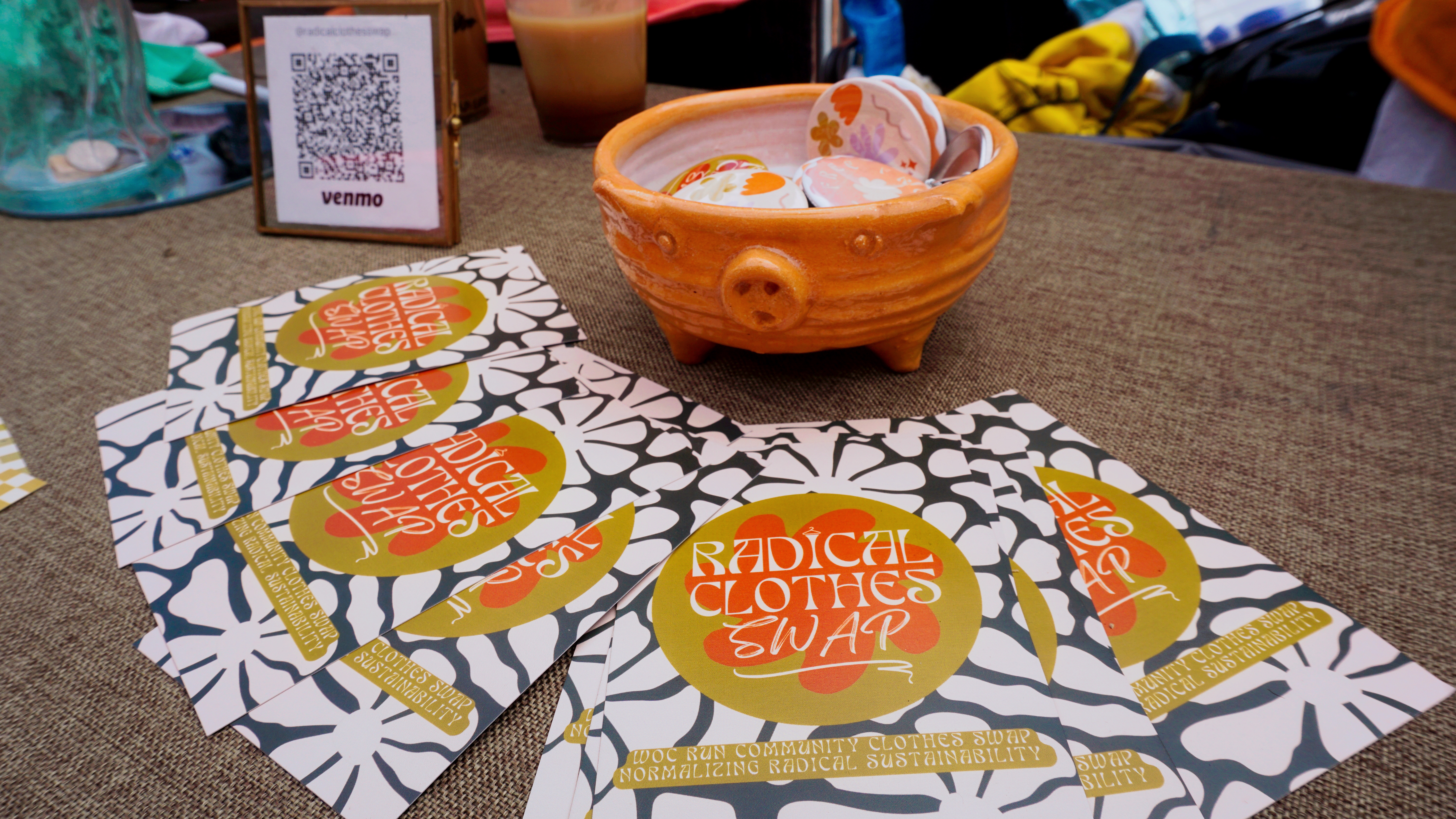 Pig dish full of RCS pins and postcards laid out on a table.