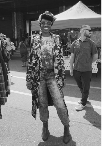 Raddie Baddie smiles in a stylish outfit