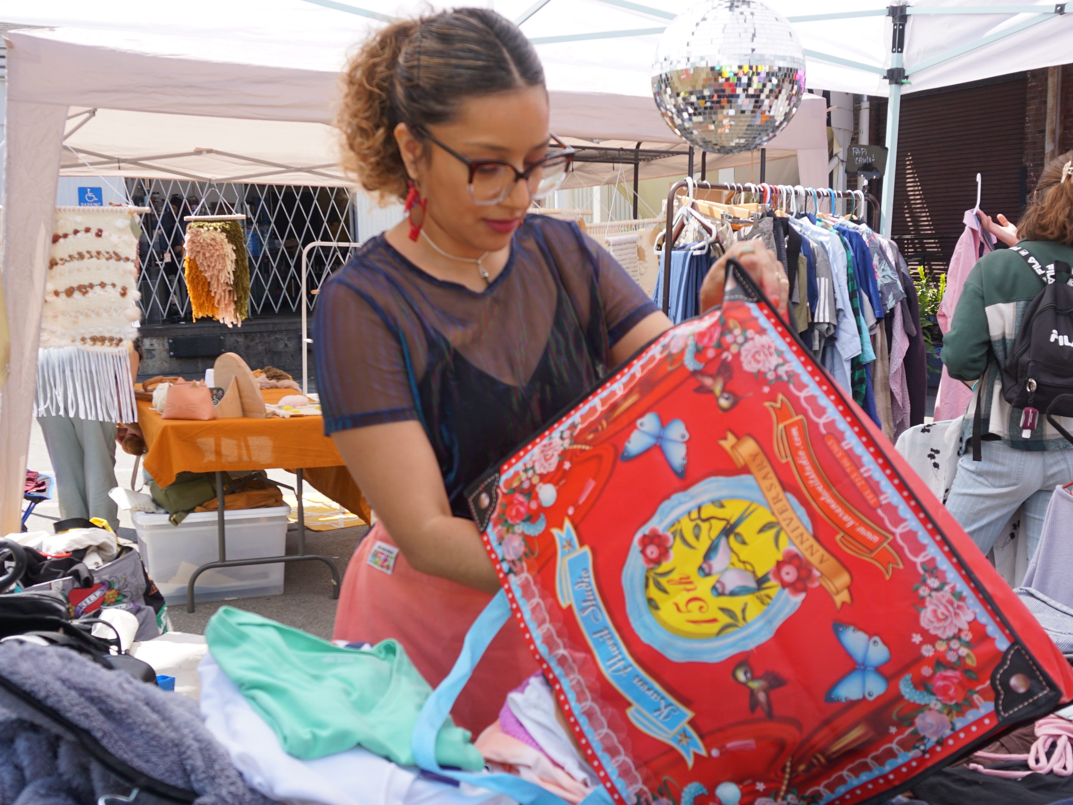 Nicole looks through clothing donations.